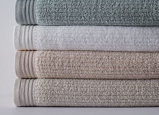 https://www.thecompanystore.com/dw/image/v2/BJVF_PRD/on/demandware.static/-/Sites-TCS-Library/default/dw7c726226/images/blog/how-to-choose-a-bath-mat-or-rug/stacked_towels.jpeg