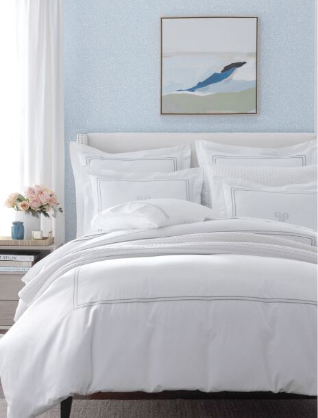 white bed with blue wallpaper