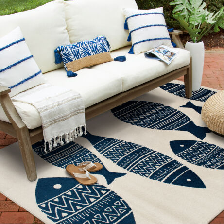 Outdoor sofa with blue and white rug